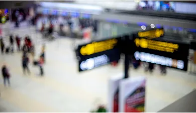 Blurred airport departure signs